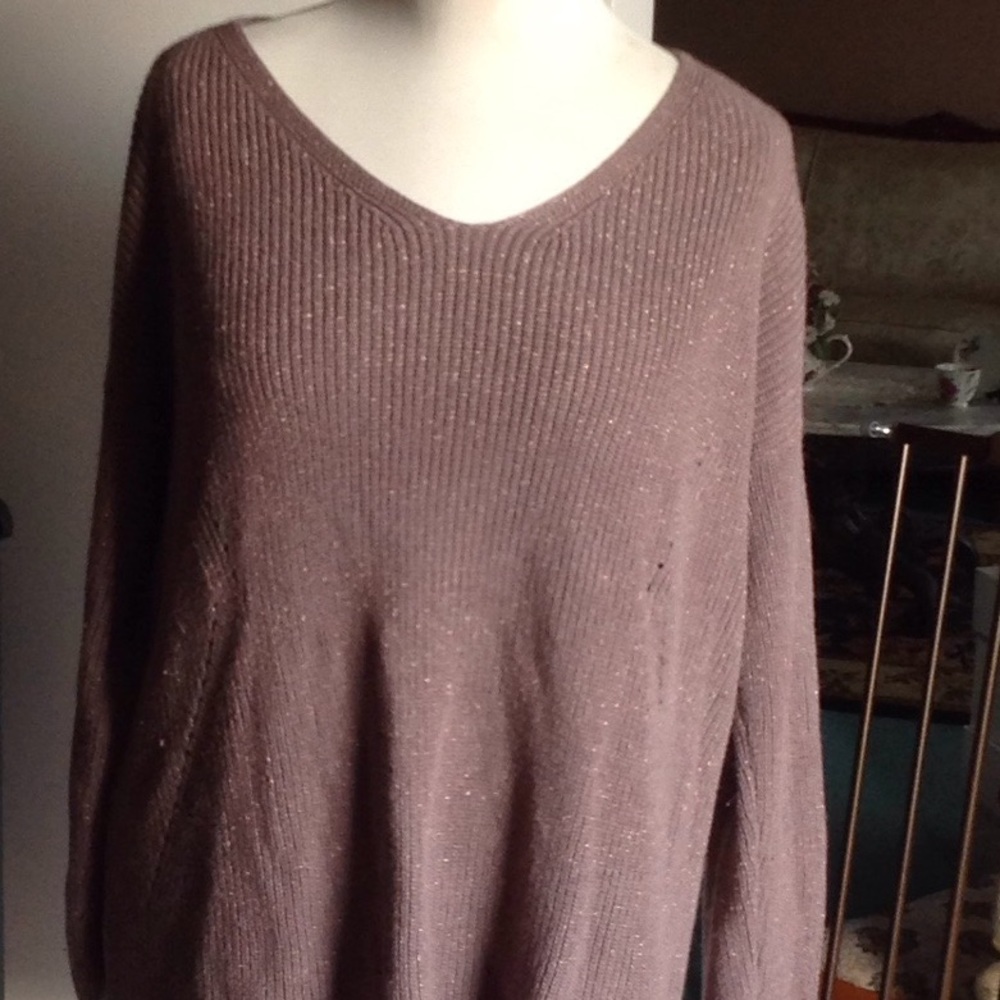 Women's long sleeved light brown cotton sweater.